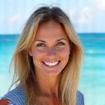Portrait of Elara Vance, smiling, with a beach scene subtly in the background.